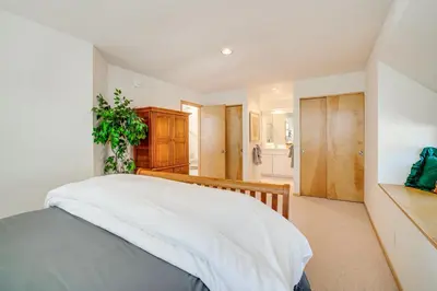 a bedroom with a bed with white sheets at Mtn-View Deck, Workspace! Walkable Frisco Condo in Frisco