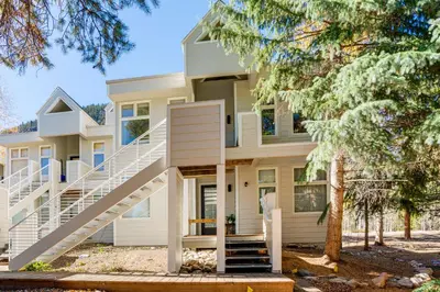 a house with a staircase in front of it at Mtn-View Deck, Workspace! Walkable Frisco Condo in Frisco