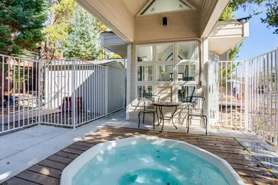a hot tub on the deck of a house at Mtn-View Deck, Workspace! Walkable Frisco Condo in Frisco