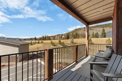 a deck with chairs and a view of a mountain at Brightwood 105 in Keystone