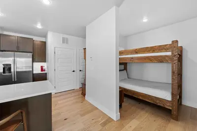 a room with a bunk bed and a kitchen at Brightwood 105 in Keystone