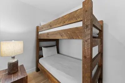 a bunk bed in a room with a lamp at Brightwood 105 in Keystone