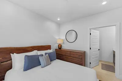 a bedroom with a large bed and a mirror at Brightwood 105 in Keystone