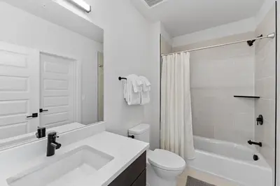 a white bathroom with a sink and a toilet at Brightwood 105 in Keystone