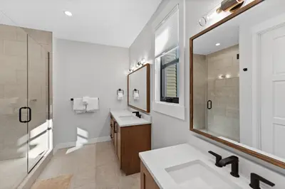 a white bathroom with two sinks and a mirror at Alcove 39 in Keystone