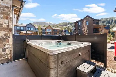 a hot tub on the balcony of a house at Alcove 39 in Keystone