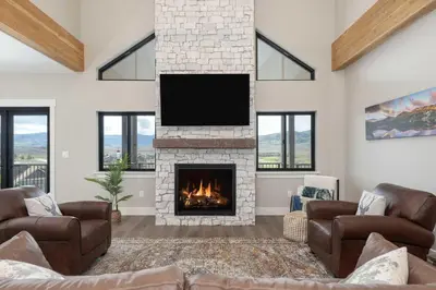 a living room with a fireplace with a flat screen tv at Saddle Ridge, 0021 in Granby