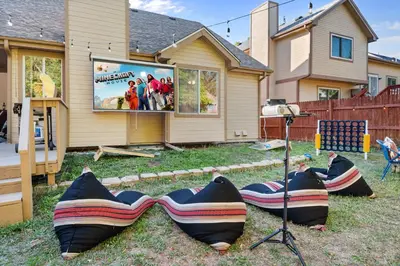 a group of large inflatable chairs in front of a house at Game Room Paradise, Firepit & Outdoor Movies in Arvada