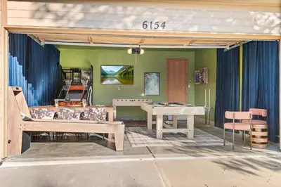 a patio with a ping pong table and chairs at Game Room Paradise, Firepit & Outdoor Movies in Arvada