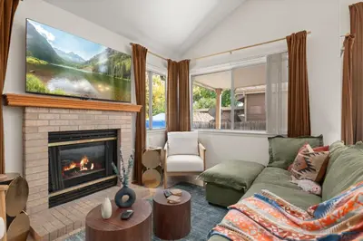 a living room with a couch and a fireplace at Game Room Paradise, Firepit & Outdoor Movies in Arvada