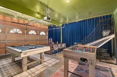 a room with a pool table and a slide at Game Room Paradise, Firepit & Outdoor Movies in Arvada