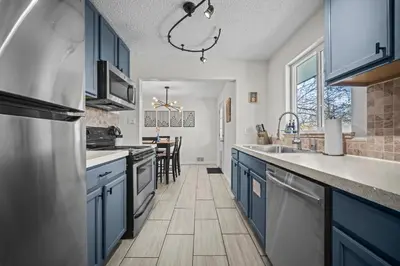 a kitchen with blue cabinets and a counter top at Family Home - Dog-Friendly - Fire Pit in Arvada