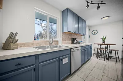 a kitchen with blue cabinets and a sink at Family Home - Dog-Friendly - Fire Pit in Arvada