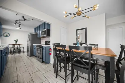 a kitchen and dining room with a table and chairs at Family Home - Dog-Friendly - Fire Pit in Arvada