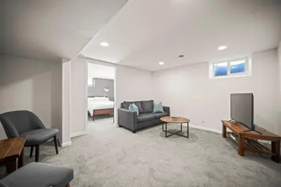 a living room with a couch and a tv and a bed at Family Home - Dog-Friendly - Fire Pit in Arvada