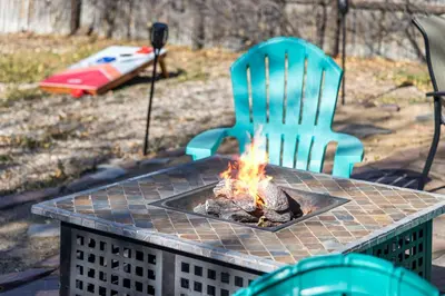 a fire pit on a table with two chairs at Family Home - Dog-Friendly - Fire Pit in Arvada