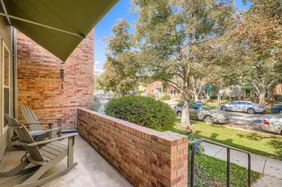 a patio with a chair and a brick wall at The Santa Fe Spot Walk to Eats, Drinks and Fun in Denver