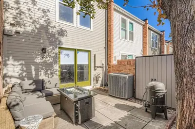a patio with a couch and a grill in front of a house at The Santa Fe Spot Walk to Eats, Drinks and Fun in Denver