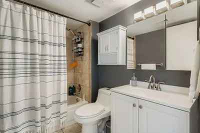 a bathroom with a white toilet and a sink at The Santa Fe Spot Walk to Eats, Drinks and Fun in Denver