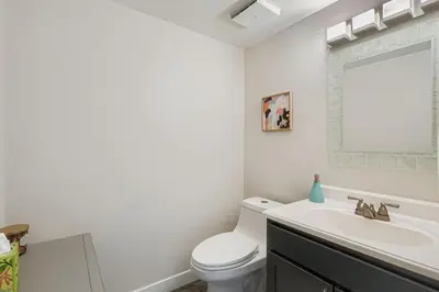 a white bathroom with a toilet and a sink at The Santa Fe Spot Walk to Eats, Drinks and Fun in Denver