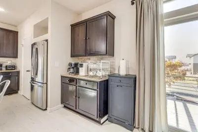 a kitchen with stainless steel appliances and wooden cabinets at Near Denver airport 20 min away from downtown in DEN