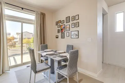 a dining room with a table and chairs and a window at Near Denver airport 20 min away from downtown in DEN