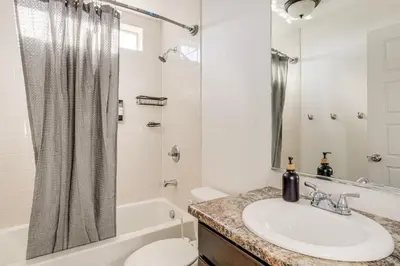 a bathroom with a sink and a tub and a toilet at Near Denver airport 20 min away from downtown in DEN