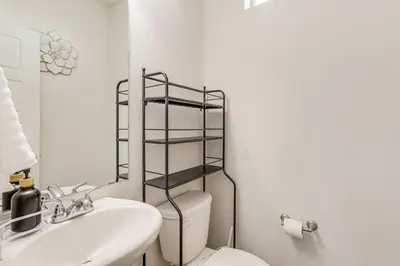 a white bathroom with a toilet and a sink at Near Denver airport 20 min away from downtown in DEN