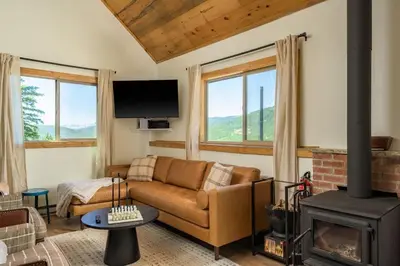 a living room with a couch and a fireplace at Skyline Lodge in Idaho Springs