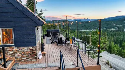 a deck with chairs and tables on top of a house at Skyline Lodge in Idaho Springs