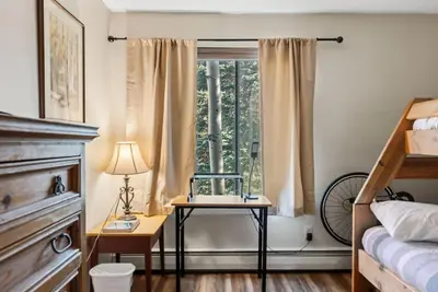 a bedroom with a table and a window at Mountain Charmer Steps to Main St and Trails in Frisco