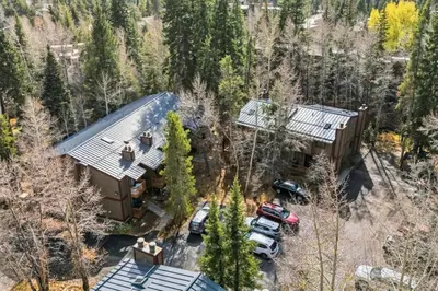 an aerial view of a house with cars parked in front at Mountain Charmer Steps to Main St and Trails in Frisco