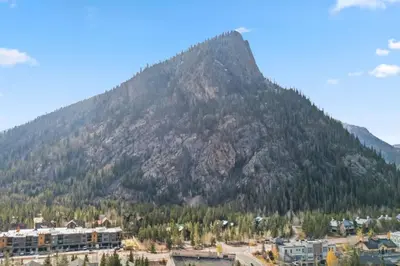 a mountain in the background of a city and buildings at Mountain Charmer Steps to Main St and Trails in Frisco