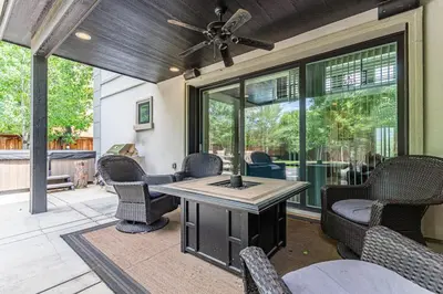 a patio with chairs and a table with a ceiling fan at Beautiful Denver City Park Home in Denver