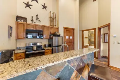 a kitchen with a counter top and a stove top oven at Arapahoe Lodge 8137 in Keystone
