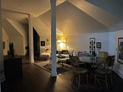 a living room with a table and a couch at Innkeeper Suite at The Currier Inn in Greeley