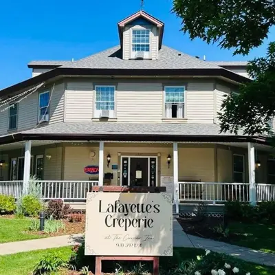 a house with a sign in front of it at Innkeeper Suite at The Currier Inn in Greeley