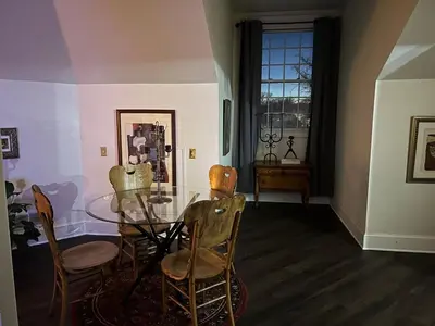 a dining room with a glass table and chairs at Innkeeper Suite at The Currier Inn in Greeley
