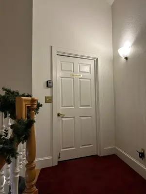 a white door with a sign on it in a room at Innkeeper Suite at The Currier Inn in Greeley