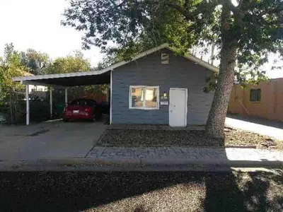 a house with a car parked in front of it at Cute 1 Bdrm Bungalow - New Flooring! in Greeley