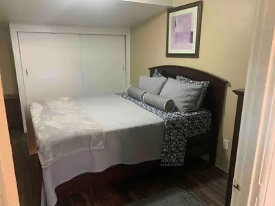 a bedroom with a large bed with pillows on it at Cute 1 Bdrm Bungalow - New Flooring! in Greeley