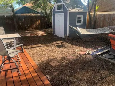 a backyard with a hammock and a shed at Cute 1 Bdrm Bungalow - New Flooring! in Greeley