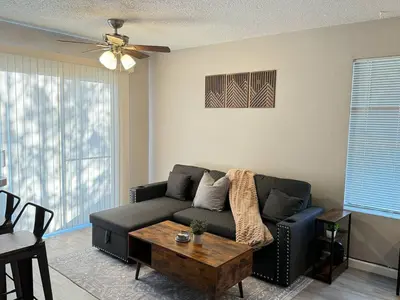 a living room with a couch and a coffee table at The Cozy Condo - Your Home Base near all amenities in Aurora