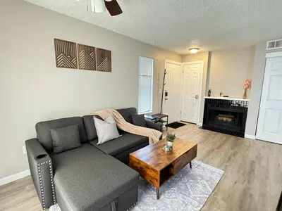 a living room with a couch and a coffee table at The Cozy Condo - Your Home Base near all amenities in Aurora
