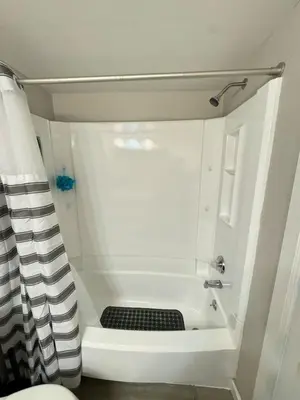 a small bathroom with a shower and a sink at The Cozy Condo - Your Home Base near all amenities in Aurora
