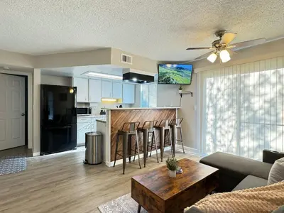 a living room with a couch and a table at The Cozy Condo - Your Home Base near all amenities in Aurora