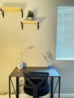 a desk with a chair and a table with a lamp at The Cozy Condo - Your Home Base near all amenities in Aurora