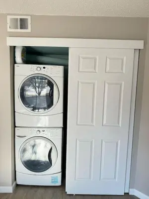 a washing machine and a washer and dryer in a room at The Cozy Condo - Your Home Base near all amenities in Aurora