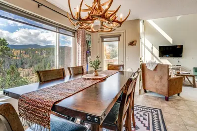 a dining room with a table and a large window at 3 Mi to Dtwn Pet-Friendly Condo in Silverthone in Silverthorne