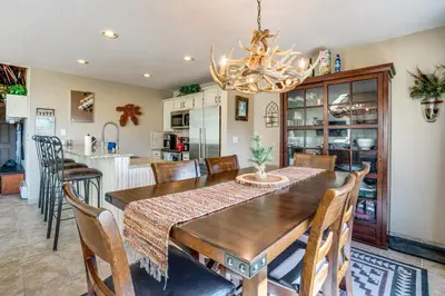 a dining room with a wooden table and chairs at 3 Mi to Dtwn Pet-Friendly Condo in Silverthone in Silverthorne